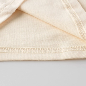 Front view of cream knit long-sleeve kids T-shirt with high-quality hem stitching details