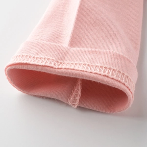 Close-up of pink long-sleeve T-shirt showing neat double-needle stitching on the hem