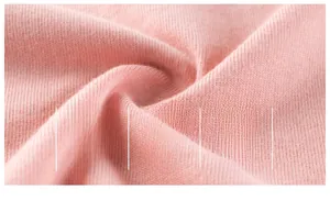 Close-up of pink cotton knit fabric showing soft, breathable, and premium texture