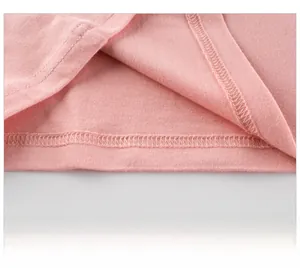 Close-up of pink long sleeve cotton shirt hem with precise stitching and neat seams