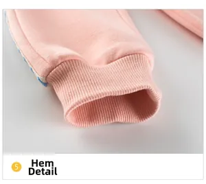Detail of pink knitted joggers showing elastic ribbed cuffs and soft cotton texture