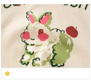 Close-up of cute hand-drawn rabbit print on light beige cotton long-sleeve tee for girls
