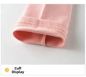 Close-up of pink long-sleeve cotton T-shirt showing ribbed cuff detail and neat double stitching