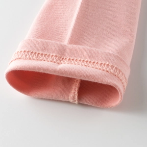 Close-up of pink long-sleeved cotton T-shirt cuff with durable double-needle stitching