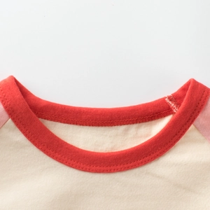Girls' raglan sleeve t-shirt featuring cream body and red ribbed contrast crew neck