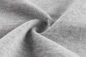 Close-up of soft grey knit fabric texture showing fine stitching and material detail