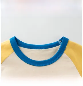 Close-up of kids' raglan sleeve t-shirt neckline with blue ribbing and yellow sleeves