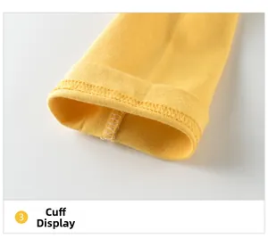 Detail view of double-stitched cuffs on a ginger yellow long-sleeve cotton girls' t-shirt