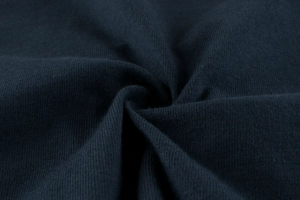 Detailed view of high-density navy blue knitted fabric texture with soft drape