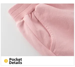 Close-up of side pocket details and soft pink knit fabric on girls' sports pants