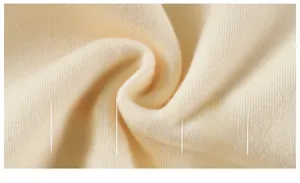 Macro detail of soft cream cotton knit fabric with breathable texture and A-level safety