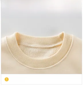 Close-up of ribbed neckline on cream fleece sweatshirt for girls with soft inner lining