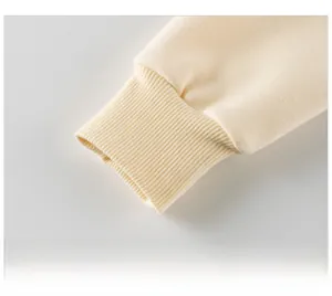 Close-up of cream-colored ribbed cuffs on a high-quality cotton knit sweatshirt