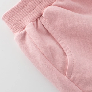 Pink cotton joggers with elastic waistband and side pocket detail for kids sports