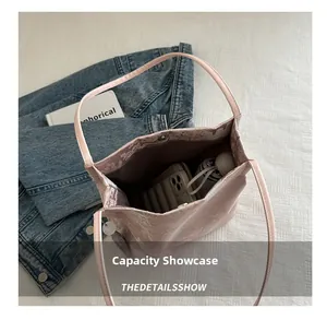 Pink jacquard tote bag showing large capacity with phone, umbrella, and daily essentials