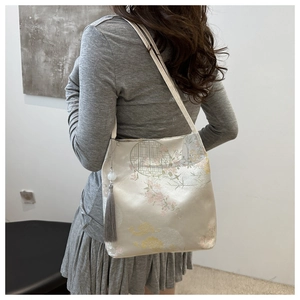 Detail of Chinese style embroidery tote bag with pavilion motifs and long silk tassel