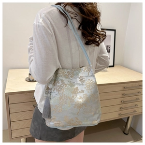 Detail view of light blue embroidery tote bag with traditional Chinese landscape patterns