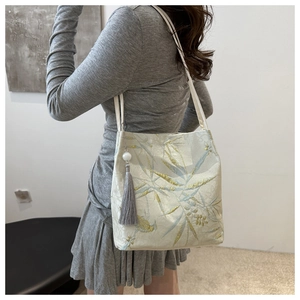 Detail of Chinese style jacquard tote bag with bamboo patterns and silk tassel accessory