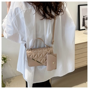 Quilted beige shoulder bag with small coin purse and elegant gold metal trim detail