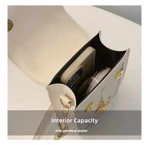 Detail show of internal capacity for white leather crossbody bag with phone and makeup