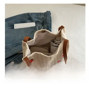 Top view of large straw tote bag with strawberry embroidery showing spacious interior