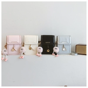 Row of mini leather crossbody phone bags in pink, white, black and silver with fuzzy charms