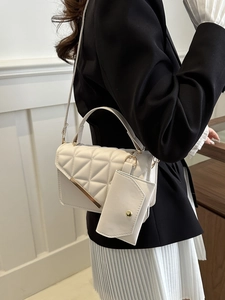 Elegant beige quilted crossbody bag for women with gold metal bar and mini pouch charm