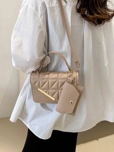 Chic khaki quilted shoulder bag with diamond pattern and gold hardware on white shirt