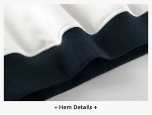 Detailed close-up of ribbed hem in navy and white stitching for children sweater