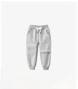 Close-up of gray kids joggers featuring elastic waistband and functional cargo pocket