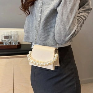 Elegant cream crossbody bag with pearl handle and metal chain strap for women