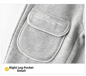 Detail of gray fleece-lined kids jogger pants showing side cargo pocket with white print