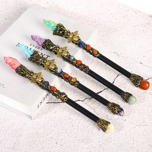Set of four vintage metal magic wands with colorful natural crystals and bee carvings