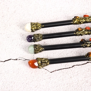 Wizard wands with metal core and natural crystals in various colors on pink stone