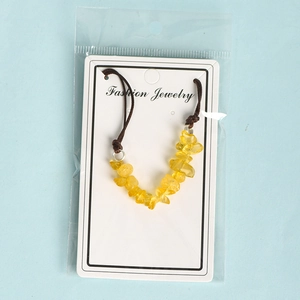 Handmade leather cord bracelet with natural yellow crystal stone chips on display card