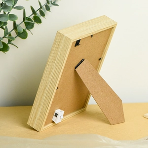 Back view of a wooden photo frame with a built-in light switch and folding stand