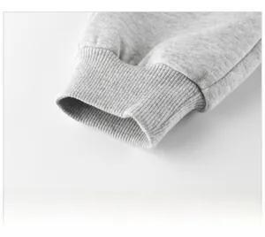 Close-up detail of grey heather fleece sweatpants featuring ribbed elastic ankle cuffs