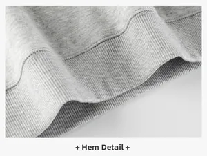 Close-up of the elastic ribbed hem detail on a gray fleece-lined children's sweatshirt