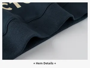 Detail view of the ribbed hem and fabric texture of the dark blue kid's sweatshirt