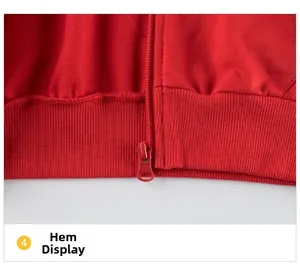Détail de l'ourlet côtelé et de la fermeture éclair d'un sweat à capuche rouge fille