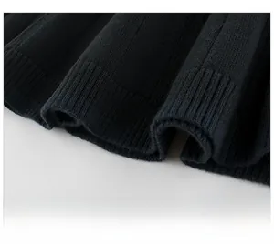 Detailed view of black knitted sweater hem featuring thick ribbed texture and premium weave