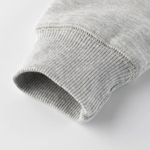 Close-up of light grey kids sweatshirt with premium ribbed cuffs and fine stitching