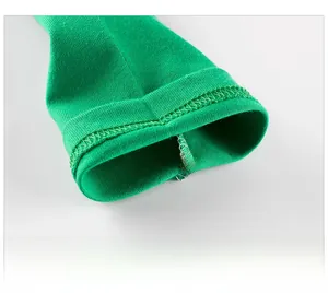 Macro detail of the green knitted cotton sleeve cuff with neat rolled edge stitching
