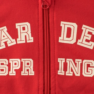 Détail de la veste à capuche rouge pour fille avec lettres imprimées et fermeture éclair