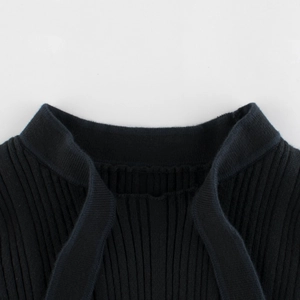 Girl's black ribbed knit sweater with standing collar shown in a detailed top view