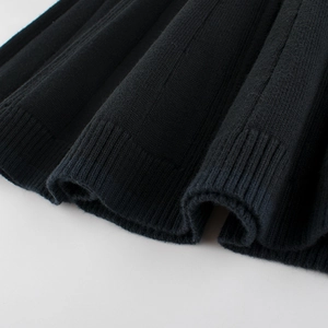 Girls' black knitted dress featuring classic ribbed cuffs and stylish vertical knit texture