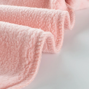 Pink plush coral fleece children sweatshirt fabric texture with soft warm material