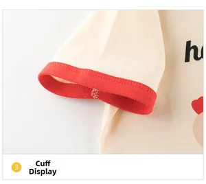 Detail view of cream cotton t-shirt sleeve with red ribbed cuff and heart print