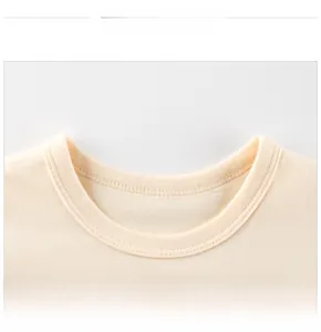 Close-up of a reinforced ribbed neckline on a cream cotton T-shirt with double stitching
