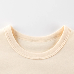Close-up of beige cotton knit t-shirt neckline with reinforced stitching and round neck